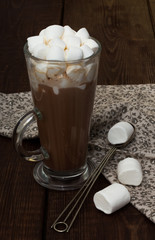 Cup of hot cocoa with marshmallows on the wooden table