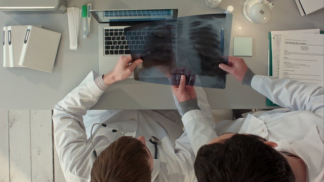 Top view of Medical team looking at xray together at the hospital