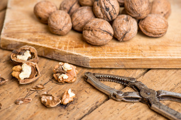 walnuts and nutcracker on an old wooden rustic table