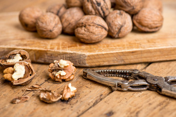 walnuts and nutcracker on an old wooden rustic table