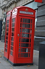 Obraz premium traditional British red phone boxes in London city centre street.