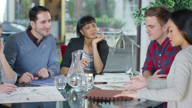  Business group in a meeting looking over the company figures