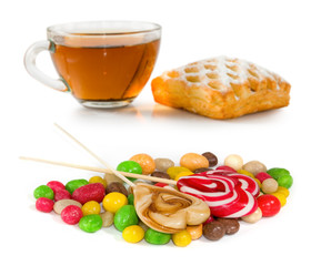Isolated image of cup of tea, candy and cookies on a white background close-up