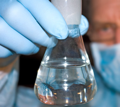 image of biotechnologist with flask  close-up