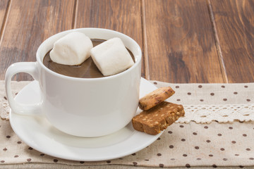 Mug filled with homemade hot chocolate and marshmallow, cookie