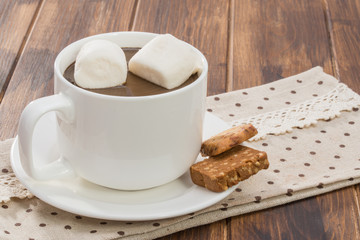 Mug filled with homemade hot chocolate and marshmallow, cookie