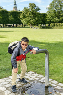 Boy At Fountain / Boy getting a much need drink from a water fountain in a parck