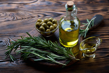 Fresh rosemary, extra virgin olive oil and green olives, closeup