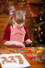 Little girl preparing Christmas cookies