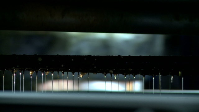 View of glue droplets falling on chipboard