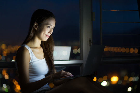 Woman use of the laptop computer at night