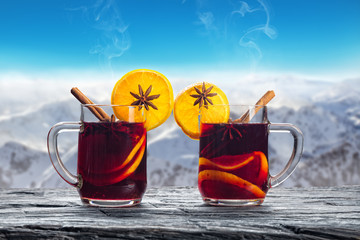 Hot red wine drinks on wooden table