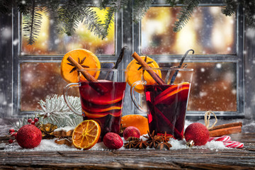 Hot red wine drinks on wooden table
