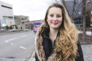 Portrait of a teen girl with long hair in an urban environment