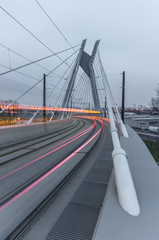 Tram lights trails on tram cable-stayed bridge in Krakow, Poland