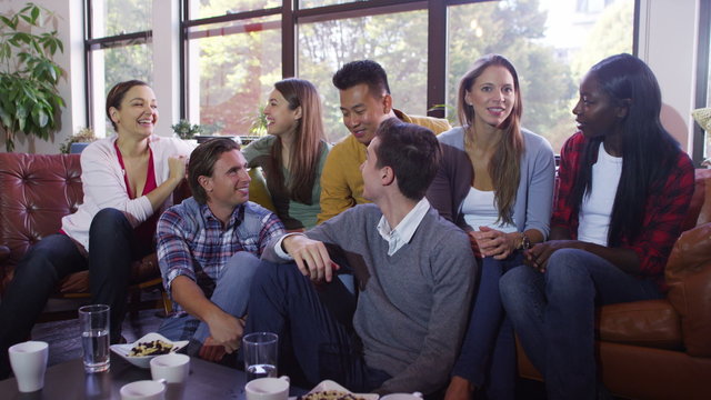  Group of students studying and relaxing together in shared apartment