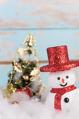 Christmas snowman and gifts decorated on grunge blue wooden back