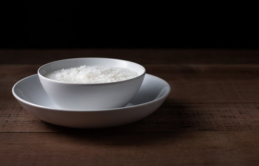 Gruel in white bowl on wooden background
