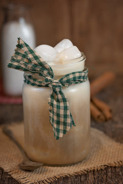 Iced Coffee In Mason Jar In Rustic Setting