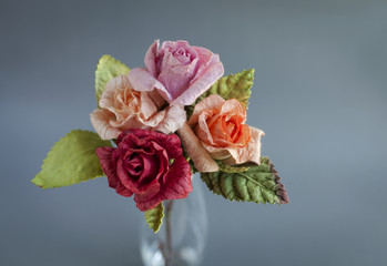 Closeup colorful roases papaer flower with grey background
