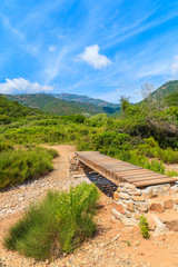 Wooden footbridge on mountain trail to Girolata bay, Corsica island, France