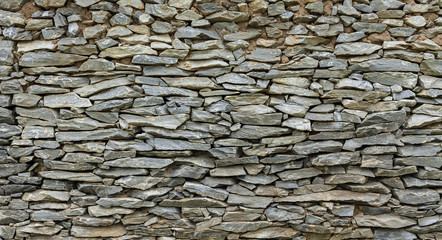 Grey stone wall background with natural light 