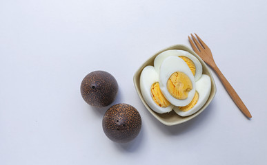 Hard boil egg with wooden salt and papper shaker on white background