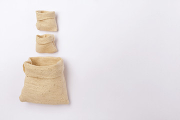 Small empty canvas bags on white background