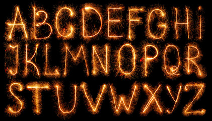 Alphabet made of sparklers isolated on black