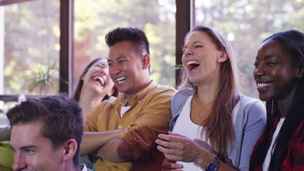  Group of students studying and relaxing together in shared apartment