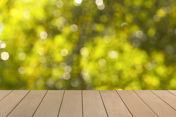 Wooden floor with blur natural green bokeh background