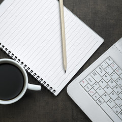 Blank notepad, laptop and coffee cup