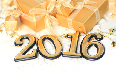 2016 year golden figures on the background of christmas decorations