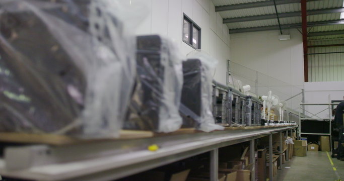 Rows of computers ready for dispatch in a British electronics factory