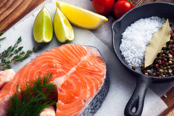  fresh raw salmon steaks with salt, peppers, lemon, tomatoes and dill