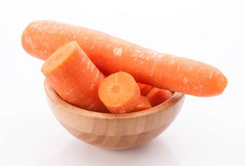 whole carrots and cut in wooden bowl isolated on white