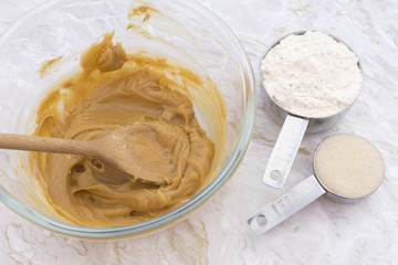 Cups of flour and sugar with peanut butter mixture