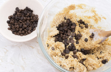 Adding chocolate chips to cookie dough