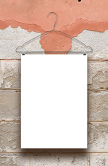 One vertical sheet frame with clothes hanger on orange and grey cracked plastered wall background