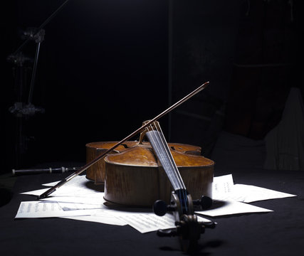 Vintage cello on wooden background
