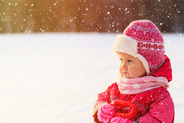 cute happy little girl play in winter