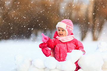 cute happy little girl play in winter