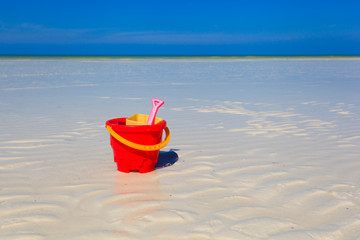 kids toys on white sand beach