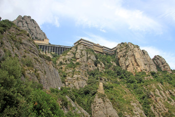 Fototapeta na wymiar MONTSERRAT, SPAIN - AUGUST 28, 2012: Benedictine abbey Santa Maria de Montserrat in Monistrol de Montserrat, Spain