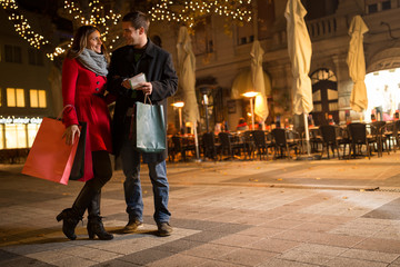 cheerful young people doing Christmas shopping © luckybusiness