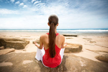 Fototapeta na wymiar Peaceful woman meditating by ocean