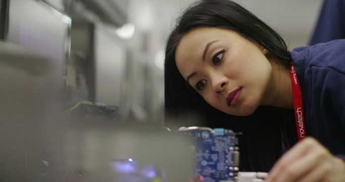 Workers building computers in a British electronics factory