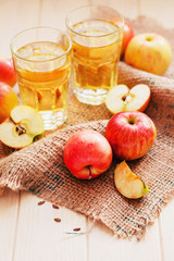 
apple cider with fresh apples , cinnamon , spices and chips on a wooden background