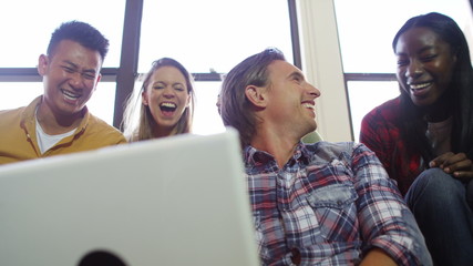  Portrait of cheerful young man writing on a notepad in shared apartment