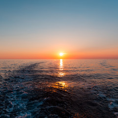 Sea sunset with ship trace
